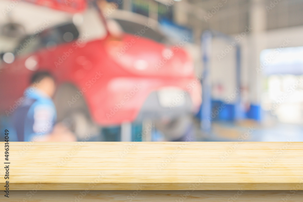 Obraz premium Empty wood table top with car service centre auto repair workshop blurred background
