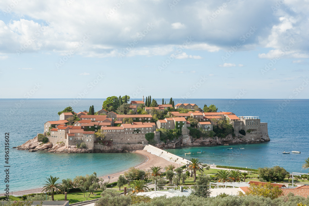 Sveti Stefan island with a promenade and beaches for branding, calendar, card, screensaver, wallpaper, poster, banner, cover, website. A place for your design or text. Top view from the Jadran road