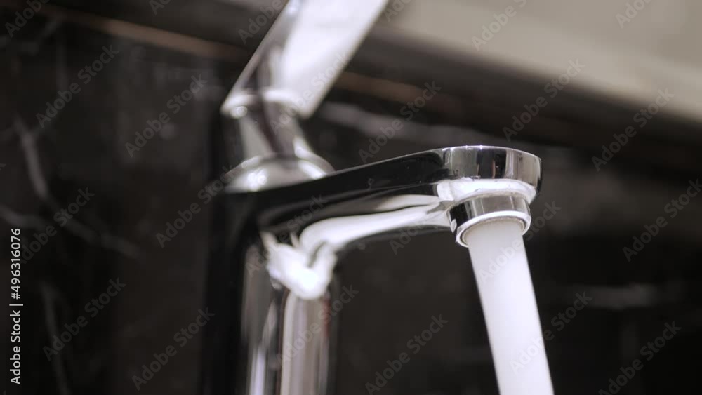 Washing hands under running water from the Tap faucent in toilet Washing hands under running water from the Tap faucent in toilet