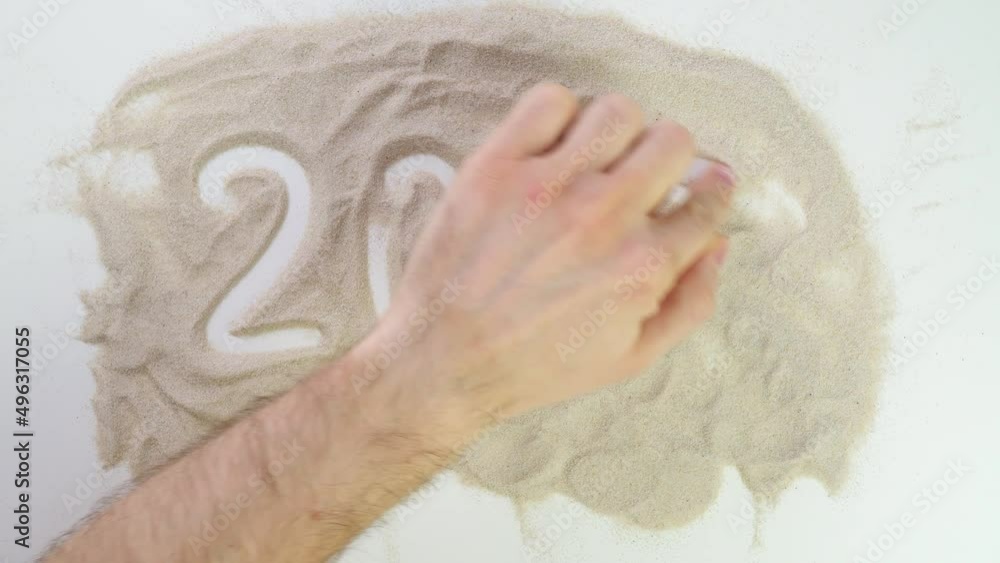 2022 text Top view draw on the sand. Caucasian hands write text in beige sand. Vacation and travel. Beach on vacation. Sand painting. Creativity from natural materials. 2022 text Top view draw on the sand. Caucasian hands write text in beige sand. Vacation and travel. Beach on vacation. Sand painting. Creativity from natural materials.