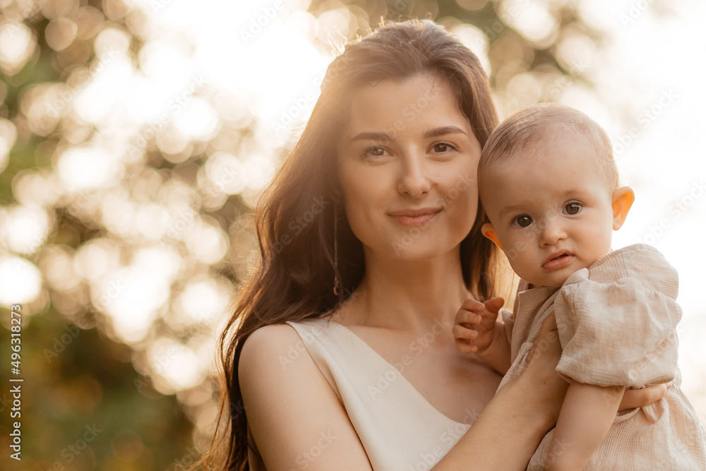 cute portrait of mom and her baby that she holds in her arms cute portrait of mom and her baby that she holds in her arms
