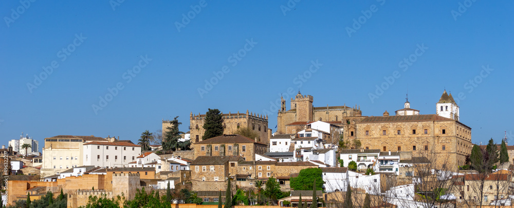 the historic old city center of Caceres under a blue sky