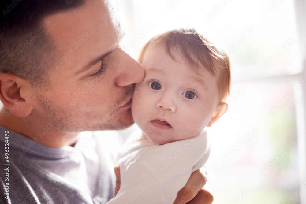 Daddys little girl. Shot of a young father kissing his baby daughter. Daddys little girl. Shot of a young father kissing his baby daughter.