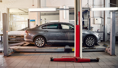 Diagnostics and configuration collapse-convergence. Car Wheels alignment equipment on stand in a repair station