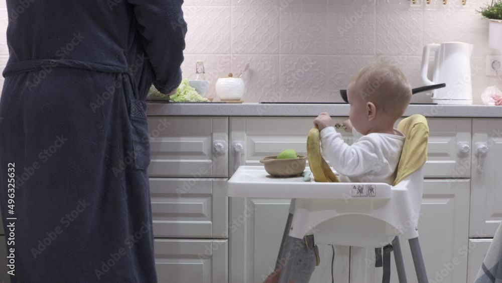Father cooks breakfast in the kitchen with his little son. High quality 4k footage Father cooks breakfast in the kitchen with his little son. High quality 4k footage