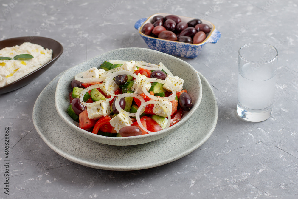 Greek salad with feta cheese, tzatziki, olives and feta cream. Traditional salad, meze, with olive oil. Greek salad with feta cheese, tzatziki, olives and feta cream. Traditional salad, meze, with olive oil.