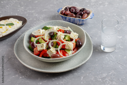 Greek salad with feta cheese, tzatziki, olives and feta cream. Traditional salad, meze, with olive oil.