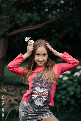 girl in nature and in rka daisy flowers photo