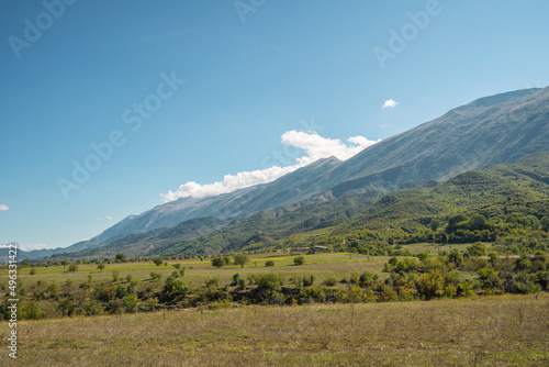 Beautiful mountain valley with gentle hills and agricultutal filds