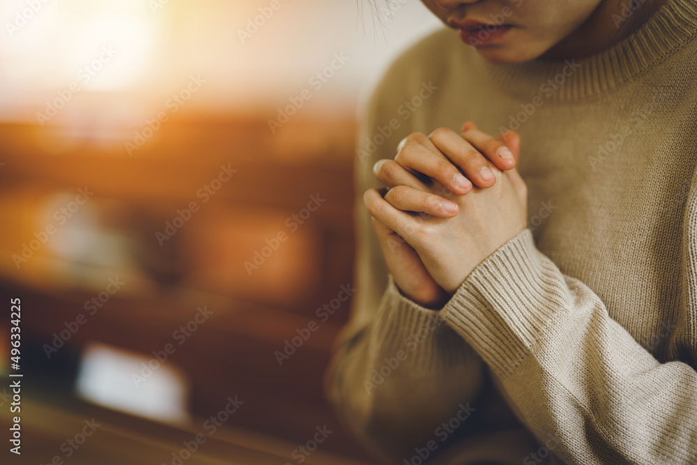 Christian life crisis prayer to god. Women Pray for god blessing to wishing have a better life. Hands praying to god with the bible. believe in goodness. Holding hands in prayer on a wooden table. - obrazy, fototapety, plakaty 