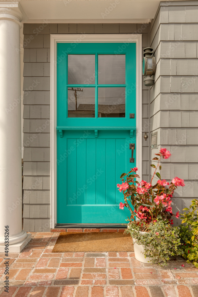A off green front door of a house.