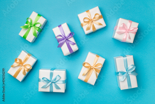 Colorful gift boxes on color background, top view