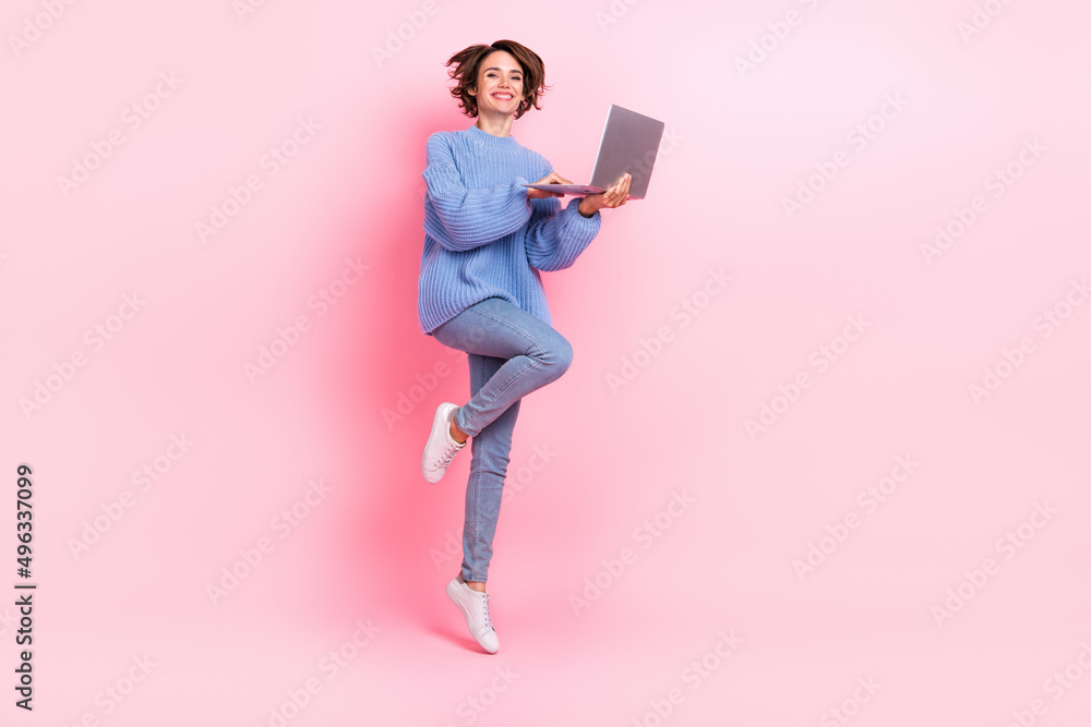 Full body portrait of active cheerful person hold wireless netbook isolated on pink color background