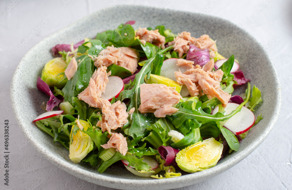 Tuna salad with lettuce, spring onions, brussels sprout, cabbage, arugula, radish and canned tuna. Vitamin salad. Close up. Tuna salad with lettuce, spring onions, brussels sprout, cabbage, arugula, radish and canned tuna. Vitamin salad. Close up.