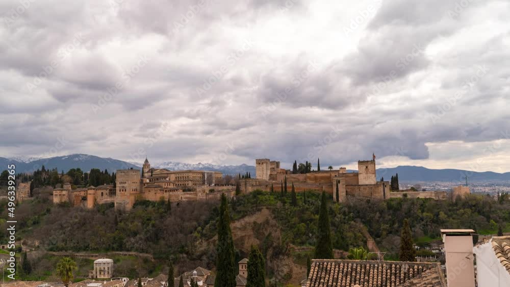 Fast moving timelapse over Alhambra Palace with mountains in Granada, Spain Fast moving timelapse over Alhambra Palace with mountains in Granada, Spain