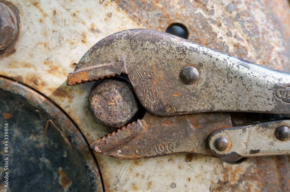 Rusty locking pliers and bolt on wheel tractors Rusty locking pliers and bolt on wheel tractors