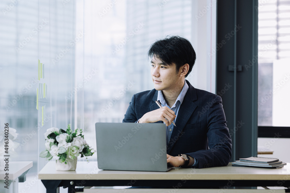 Asian man with suit, young businessman as startup company CEO, executive room, young startup company executives, run by young leaders. Management concept of startup companies and business men. Asian man with suit, young businessman as startup company CEO, executive room, young startup company executives, run by young leaders. Management concept of startup companies and business men.