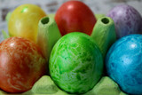 colorful easter eggs in a egg carton box close up