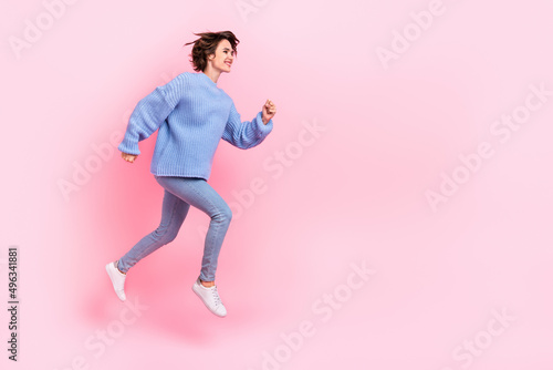 Full length profile photo of energetic pretty girl rush empty space isolated on pink color background