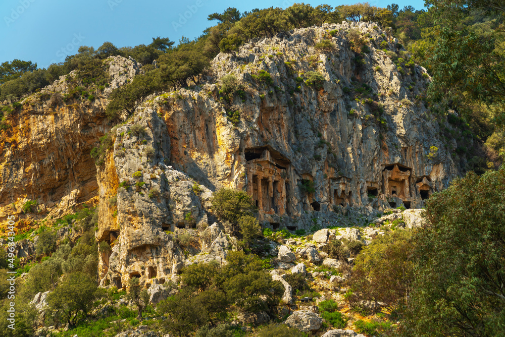 DALYAN, MUGLA, TURKEY: Lycian tombs carved into the rock in the ancient city of Kaunos. DALYAN, MUGLA, TURKEY: Lycian tombs carved into the rock in the ancient city of Kaunos.