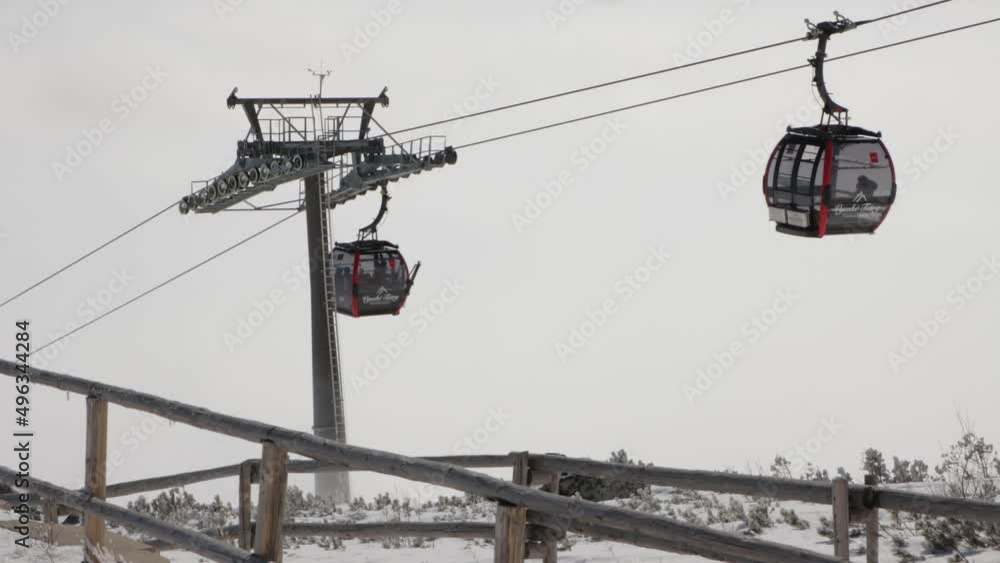 Cable transport by gondola lifts in alpine ski resort during winter Cable transport by gondola lifts in alpine ski resort during winter