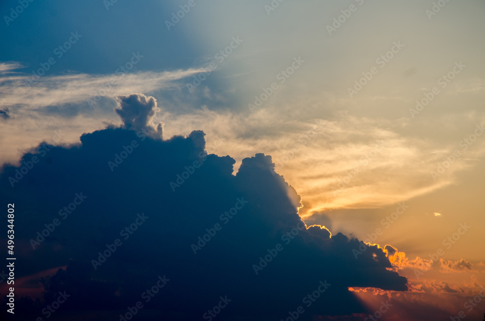 Sunset / sunrise with clouds, light rays and other atmospheric effect