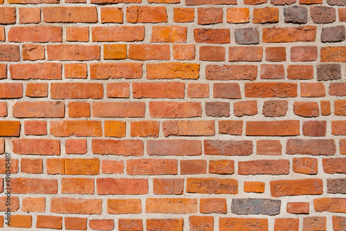 Red brick wall of a medieval building on a sunny day