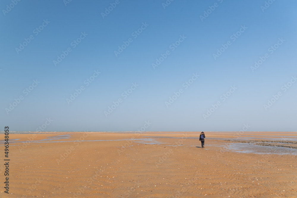 Obraz premium One person walking in an empty beach