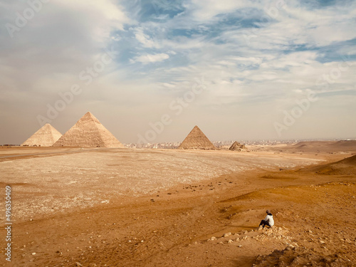 A traveler looks at the pyramids in the Giza plateau near Cairo  Egypt