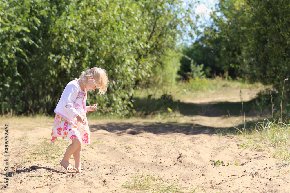 little beautiful girl playing on sand in summer park little beautiful girl playing on sand in summer park