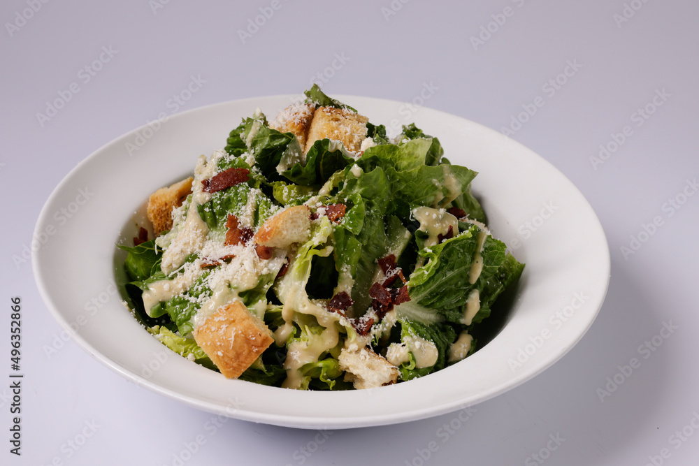 healthy CLASSIC CAESAR SALADin a dish top view on grey background singapore food healthy CLASSIC CAESAR SALADin a dish top view on grey background singapore food