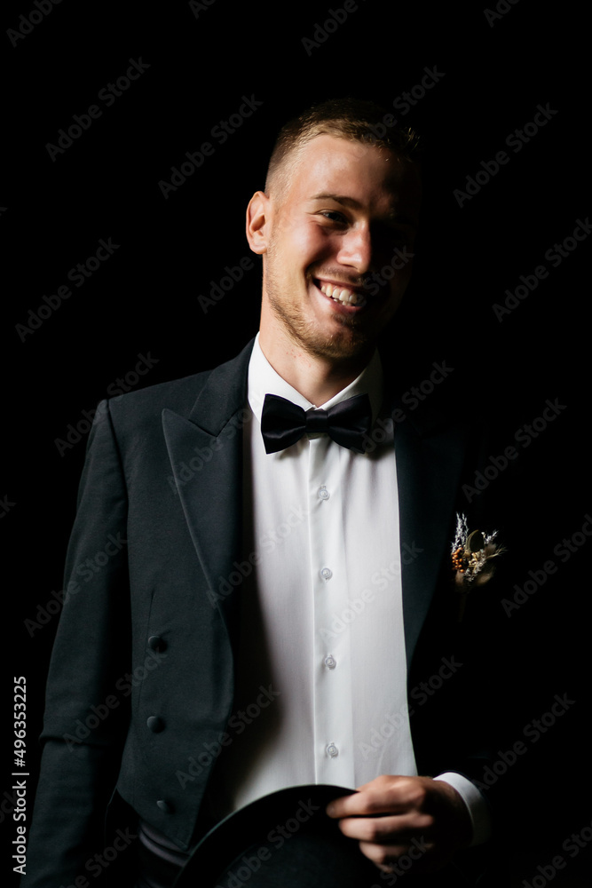 The groom in a hat. Portrait of the groom close up. The wedding. The groom in the black hat turned his head. The groom in a hat. Portrait of the groom close up. The wedding. The groom in the black hat turned his head.