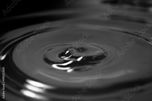 Oil slick. Wave circles from a drop on a greasy liquid surface.