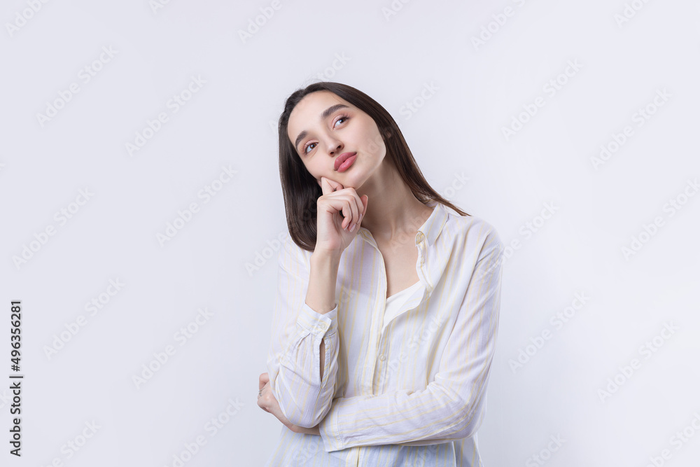 Portrait of a beautiful young woman thinking, isolated on white background Portrait of a beautiful young woman thinking, isolated on white background