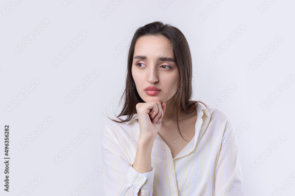 Portrait of a beautiful young woman thinking, isolated on white background Portrait of a beautiful young woman thinking, isolated on white background