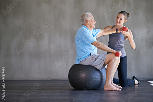 Helping patients stay strong and healthy. Shot of a a physical therapist working with a senior man.