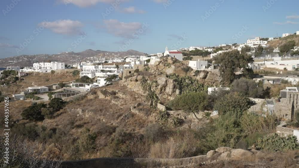 Town and windmills and Aegean Sea from elevated position, Mykonos Town, Mykonos, Cyclades, Greek Islands Town and windmills and Aegean Sea from elevated position, Mykonos Town, Mykonos, Cyclades, Greek Islands