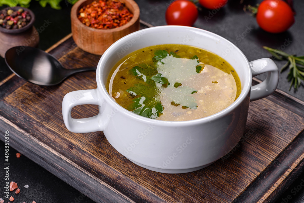 Hot tasty healthy soup with fish and vegetables served on a round plate Hot tasty healthy soup with fish and vegetables served on a round plate