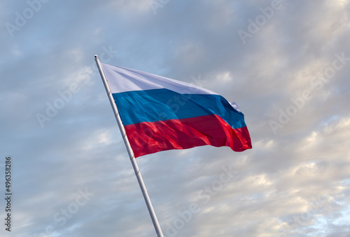 Free Download Waving Russian flag against a blue sky with clouds. - GFXLoad