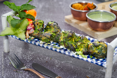 Chicken Pahadi kabab is a spicy green colored chicken kabab made using boneless chicken marinating in a yoghurt based marination with herbs and spices. photo