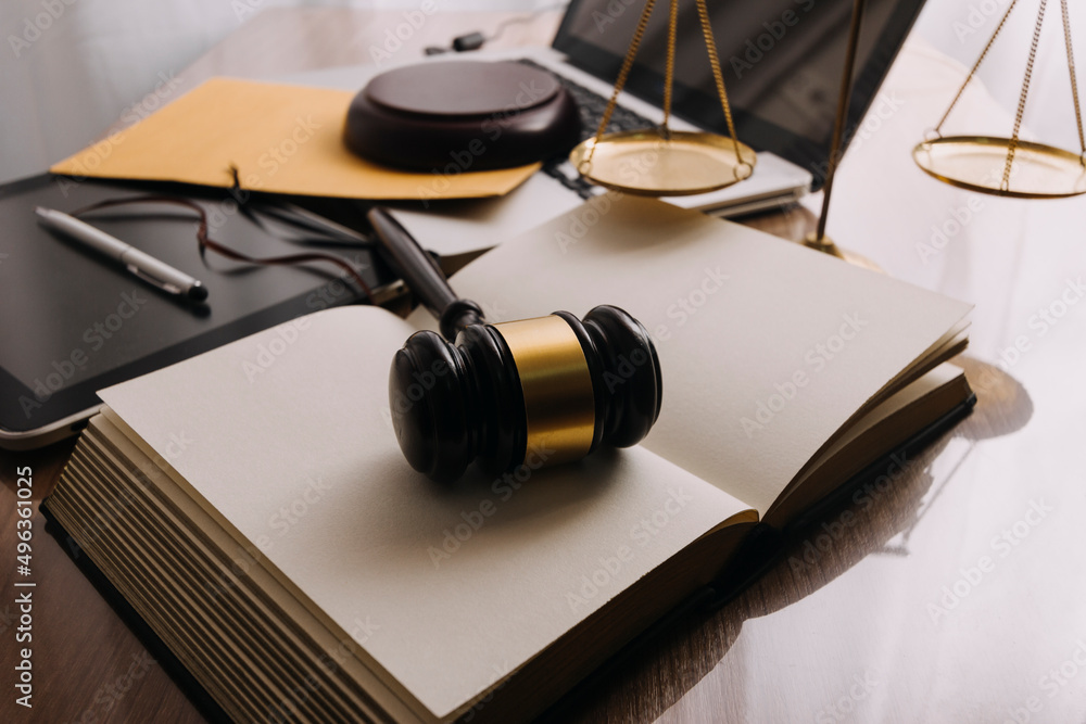 Male lawyer working with contract papers and wooden gavel on tabel in courtroom. justice and law ,attorney, court judge, concept. Male lawyer working with contract papers and wooden gavel on tabel in courtroom. justice and law ,attorney, court judge, concept.