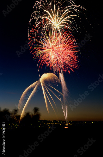Low angle view of fireworks display at night in a city photo