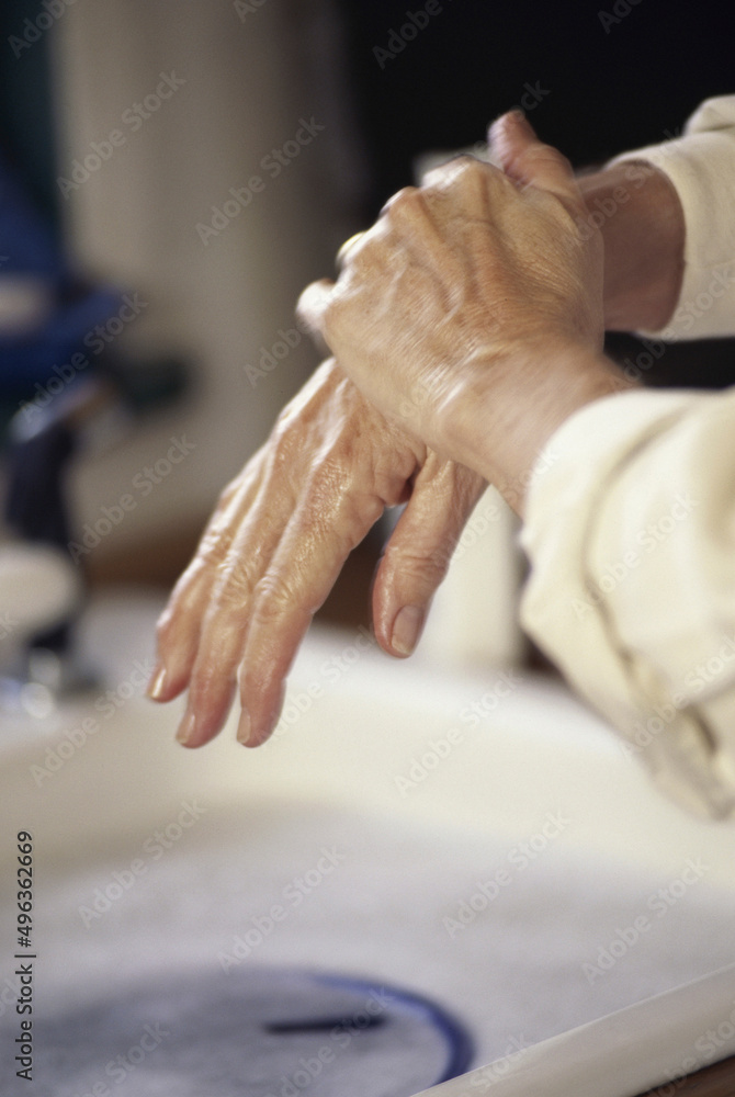 Close-up of a person rubbing their hands