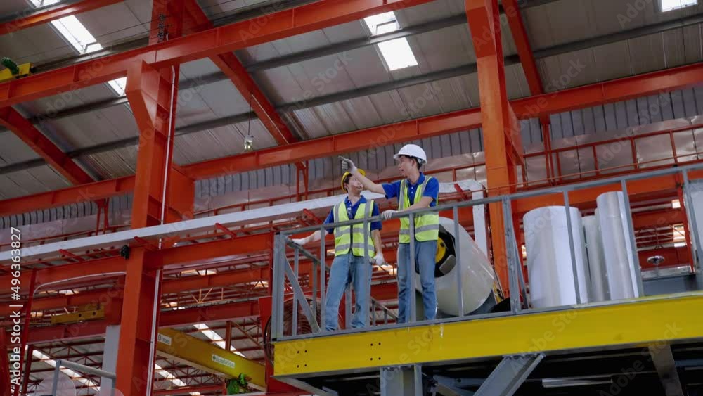 young Asian foreman was smiling and Confident in young Asian engineer explains to a foreman about a factory action plan.
young Asian foreman was smiling and Confident in young Asian engineer explains to a foreman about a factory action plan.