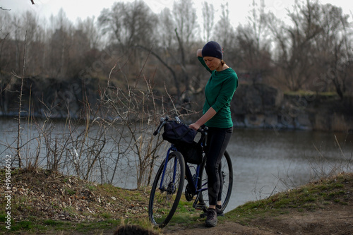 middle-aged woman rides a gravel bike in the forest in sunny weather healthy lifestyle. cycling travel. active lifestyle.