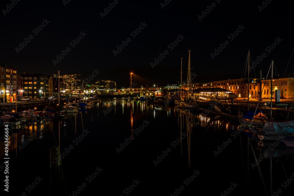 Night view of sailboats moored on the Nidelva river in Trondheim, Norway Night view of sailboats moored on the Nidelva river in Trondheim, Norway