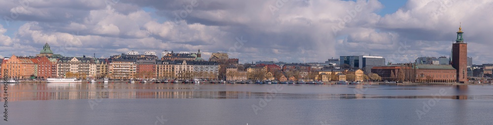 Panorama view at the bay Riddarfjärden and the down town buildings with the Town City Hall and a part of the old town Gamla Stan a sunny spring day in Stockholm