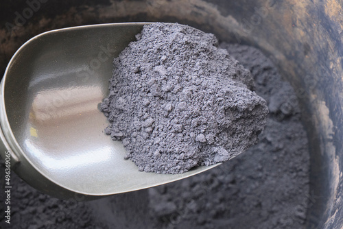 Close view of iron ore concentrate into the hand shovel