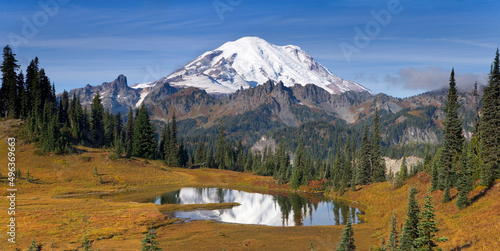 Reflection of trees and a snowcapped mountain in a lake, Tipsoo Lake, Mount Rainier, Chinook Pass, Mount Rainier National Park, Washington, USA photo