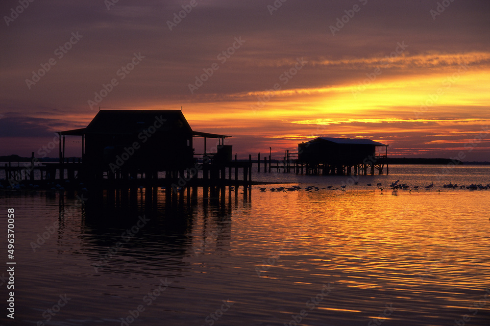 Silhouette of houses on the ocean at sunset Silhouette of houses on the ocean at sunset